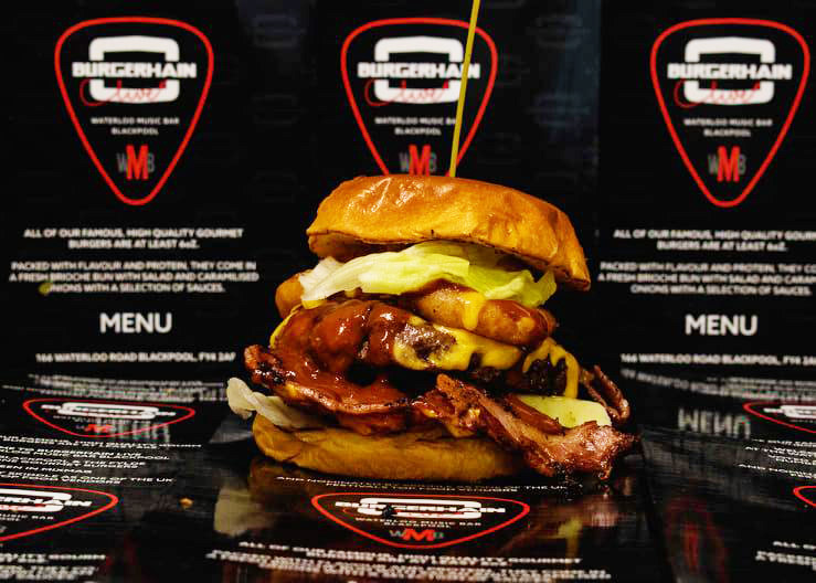 Double burger with bacon, cheese and jalapenos on the Burgerhain menu board backdrop