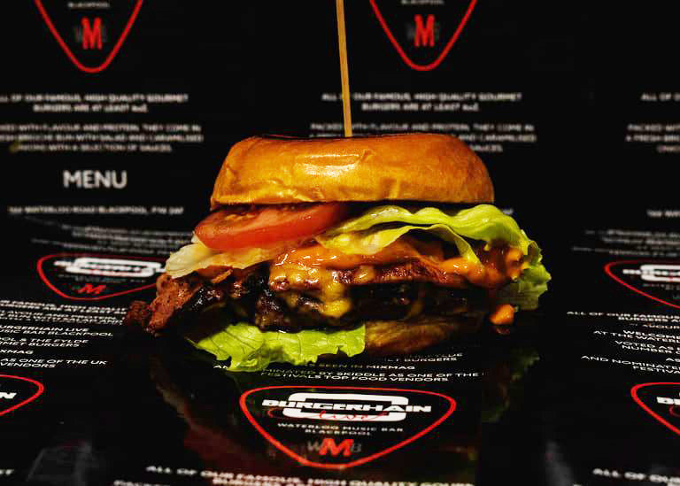 Cheeseburger with lettuce and tomato in a glazed brioche bun