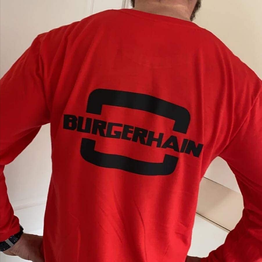 The Burgerhain logo across the back of a red Burgerhain shirt
