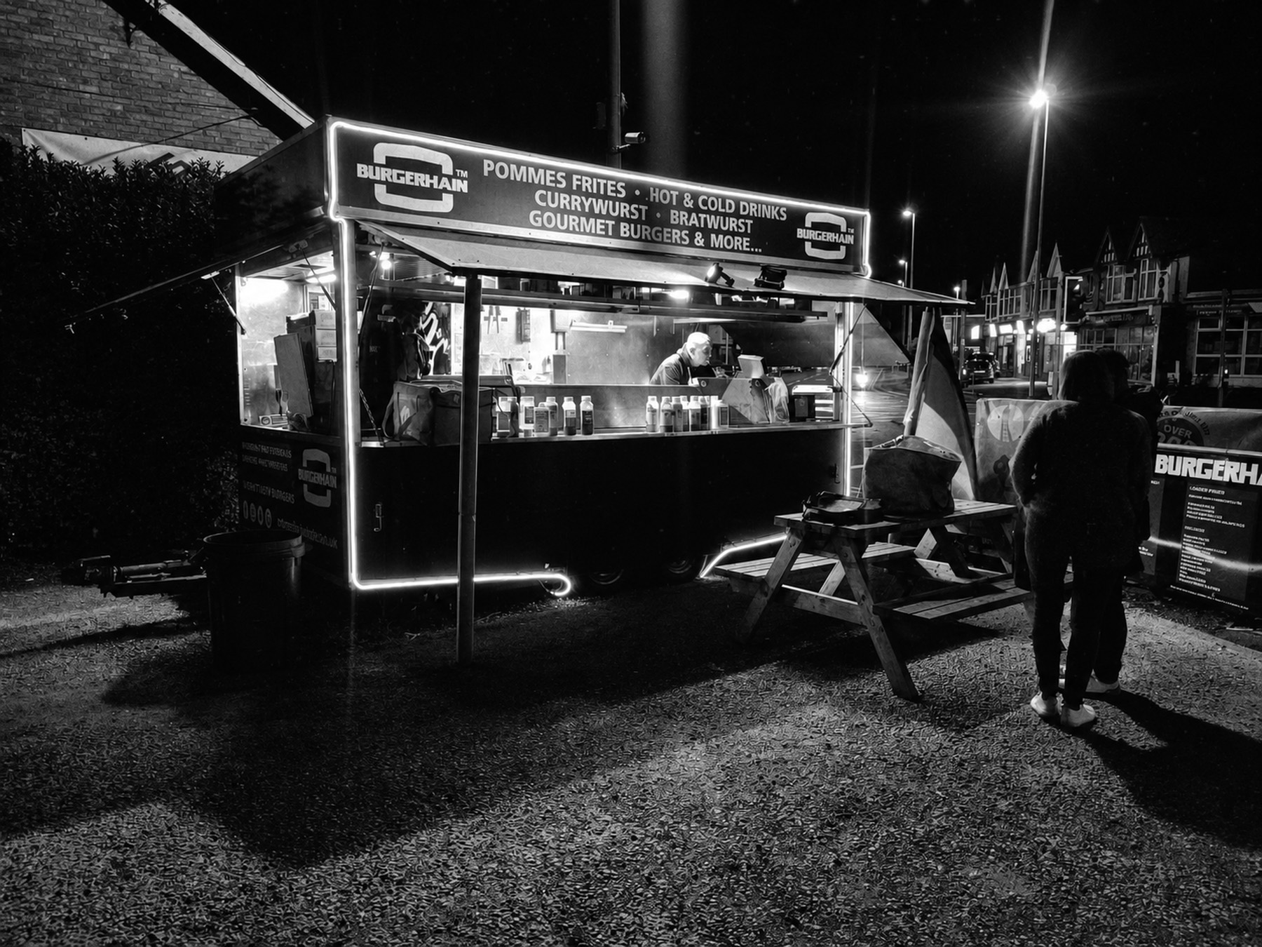 The Burgerhain street food trailer lit up at night in Blackpool, serving gourmet burgers, currywurst and pommes frites